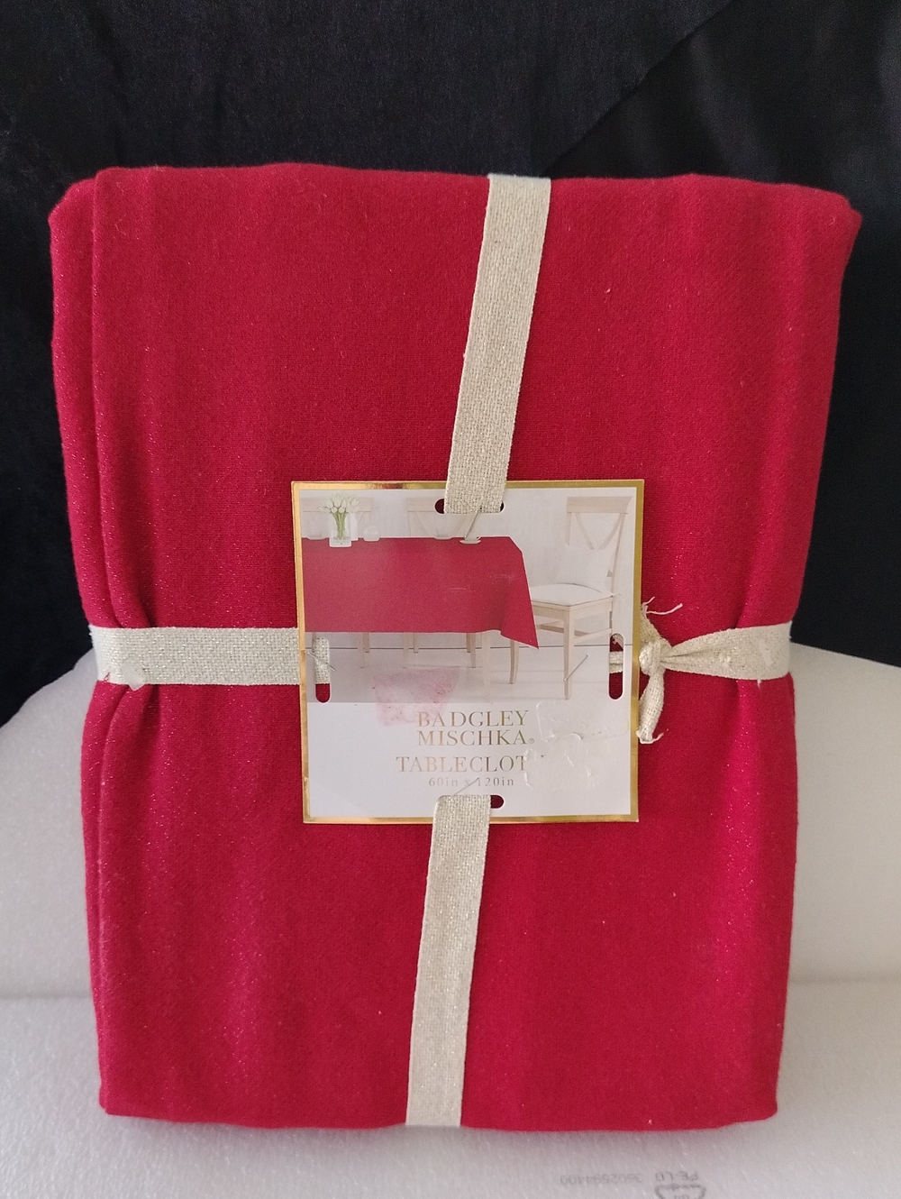 Badgley Mischka Red Rectangle tablecloth measuring 60 by 120 inches.
